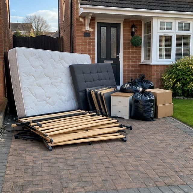 Before: a mattress and bed frame left on a driveway