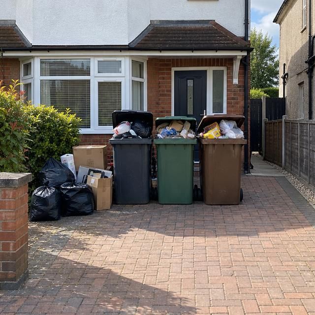 Before: overflowing wheelie bins and bags on a driveway
