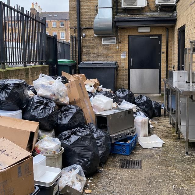 Before: bags and boxes piled in the yard behind a restaurant