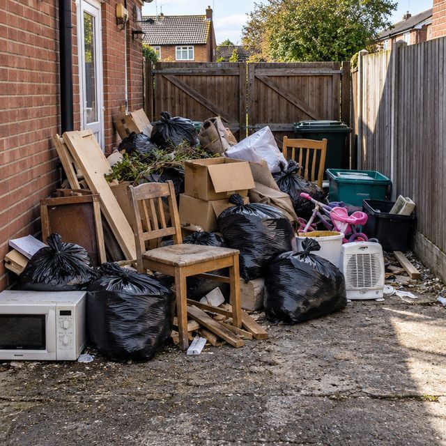 Before: bags and junk piled in a side yard