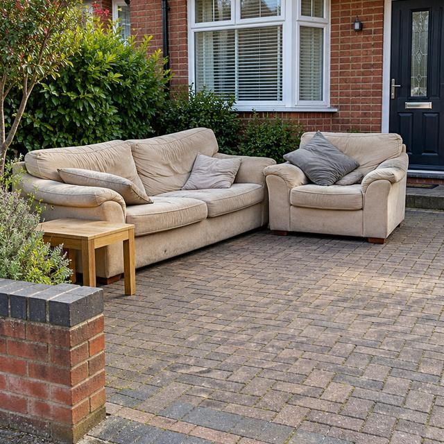 Before: two old sofas left on a driveway