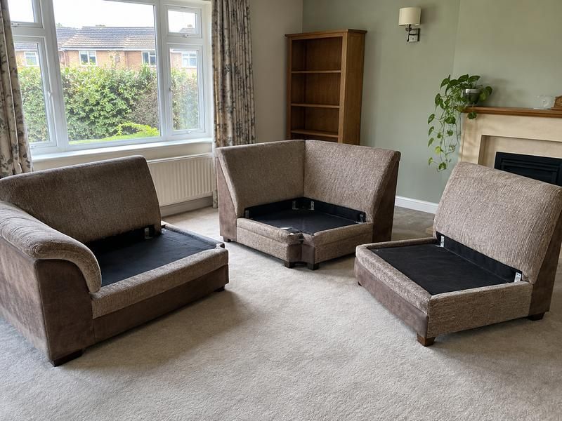 Corner sofa separated into sections in a living room ready for removal