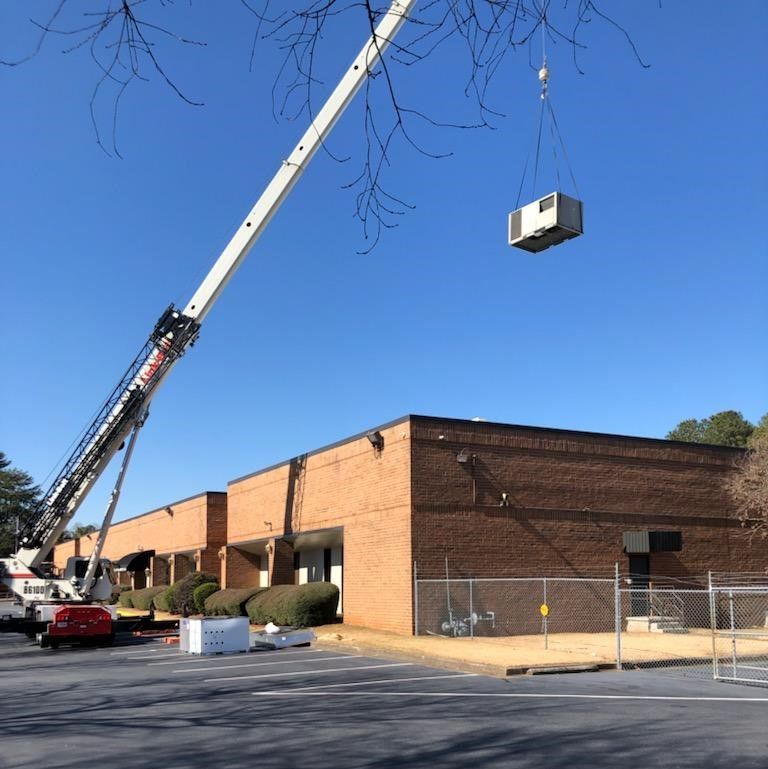 AC installation for a commercial building using a crane