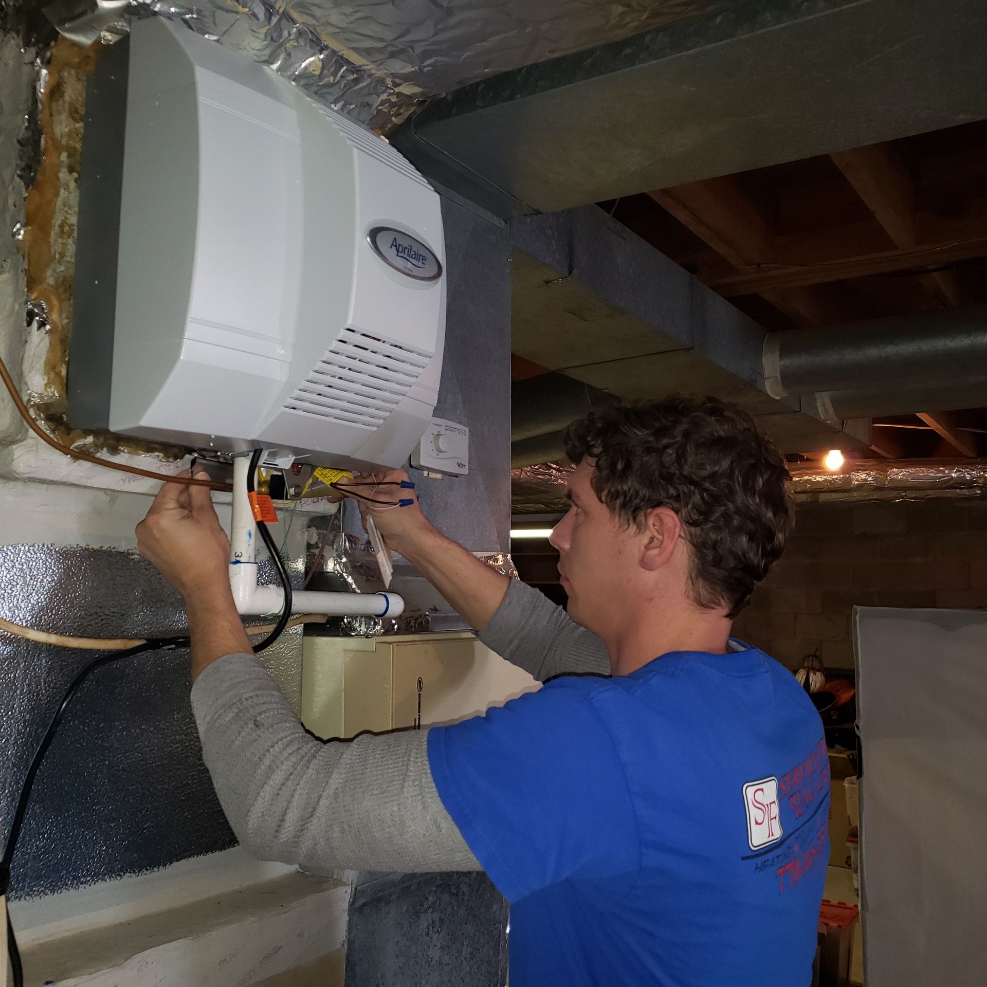 Close Up Of Mature Woman Adjusting Central Heating Temperature At Home On Thermostat