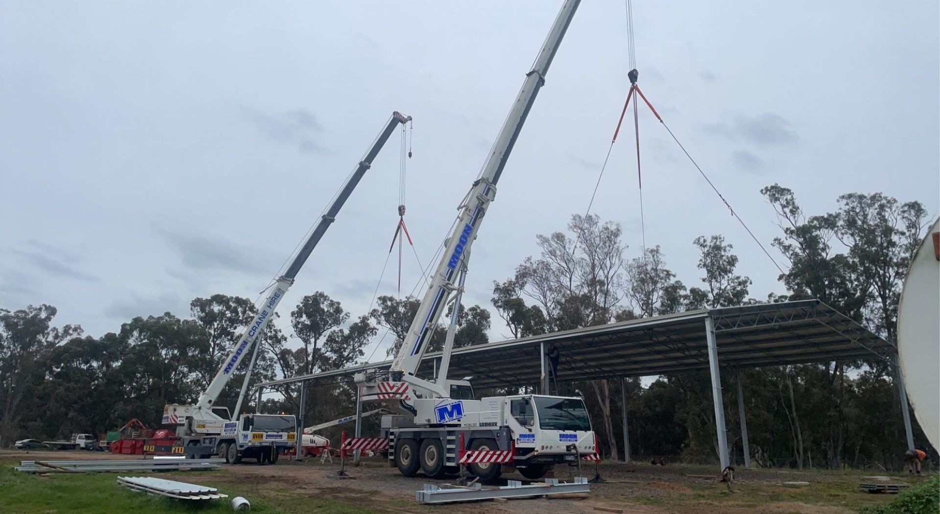 Image of Two Crane Truck Lifting a Roof — Shepparton, Vic — Moon Crane Hire