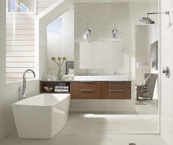 Modern white bathroom with freestanding tub, wood vanity, mirror, and glass shower
