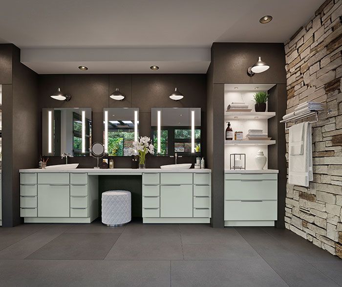Modern bathroom vanity with double sinks, large mirrors, pendant lights, and stone accent wall