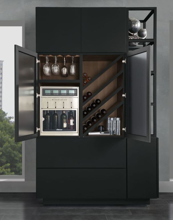 Modern black wine cabinet with open doors, bottles, glasses, and shelves in a gray room