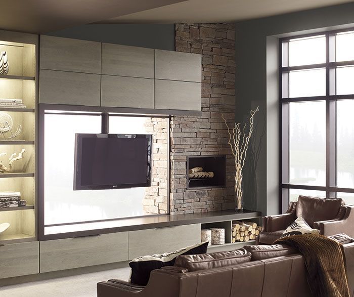 Modern living room with wall-mounted TV, fireplace, large window, and neutral-toned sofa