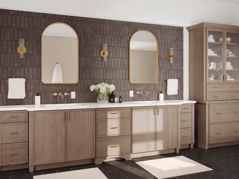 Modern bathroom vanity with wood cabinets, dark tiled wall, arched mirrors, and bright sunlight on the floor