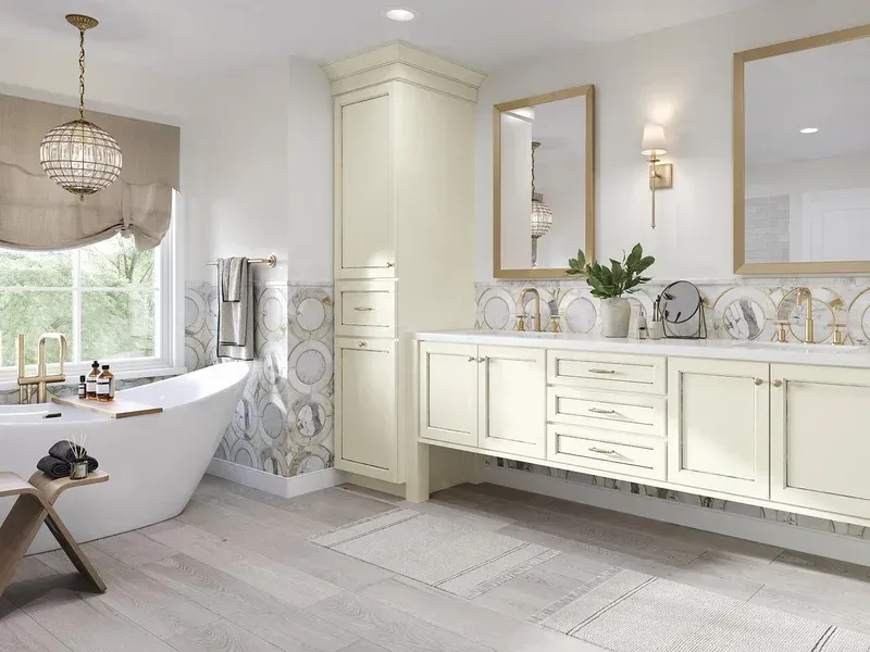 Elegant white bathroom with freestanding tub, double vanity, and gold-framed mirrors