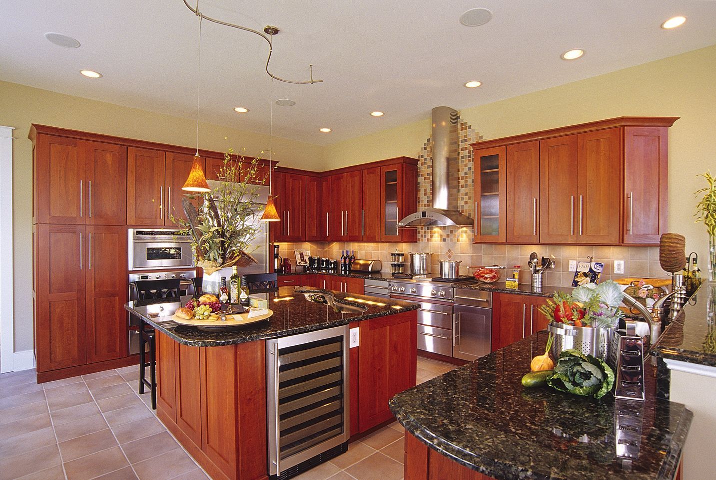 Spacious kitchen with cherry cabinets, dark granite counters, and stainless steel appliances