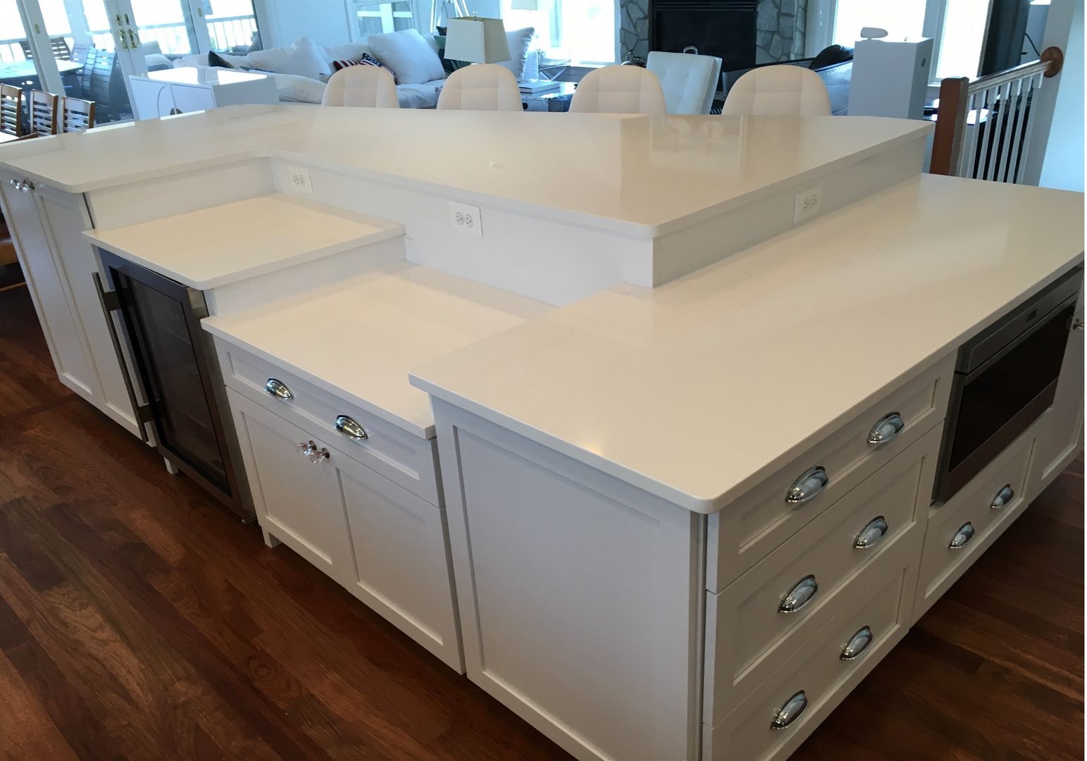 White kitchen island with drawers and cabinets in a bright showroom