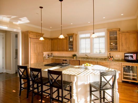 A kitchen with a large island and stools