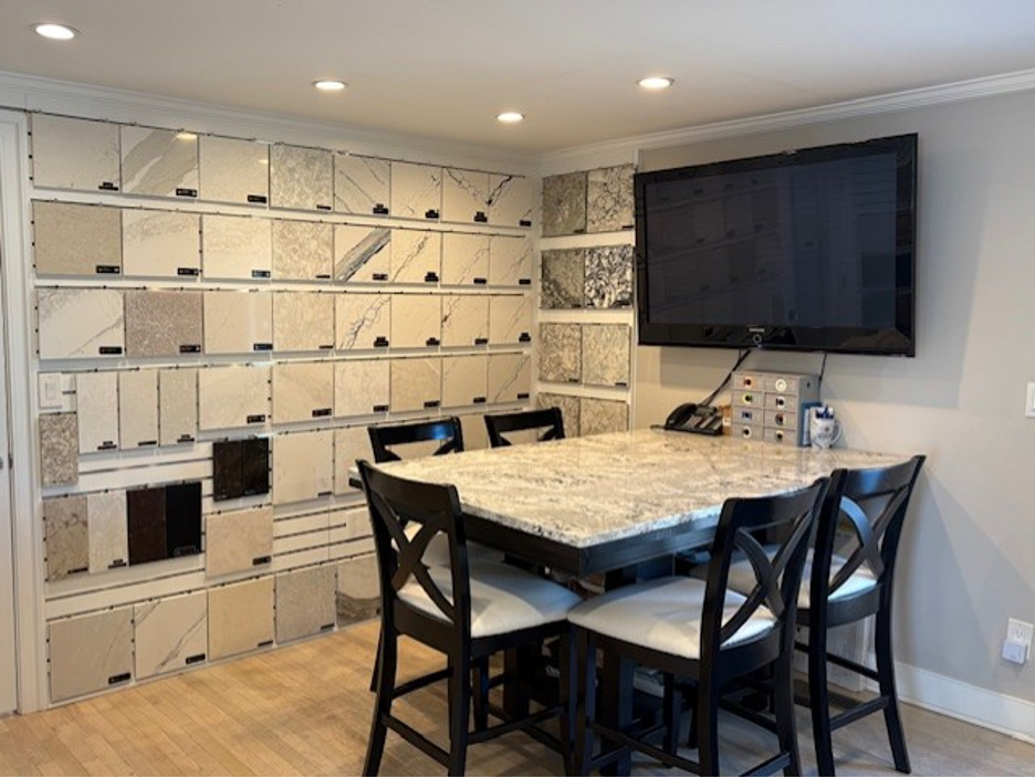 Modern office or conference room with wall cubbies, black table and chairs, and a wall-mounted TV