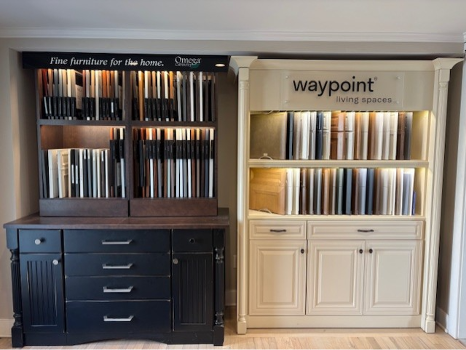 Two built-in display cabinets of books, one dark wood and one white, in a showroom.