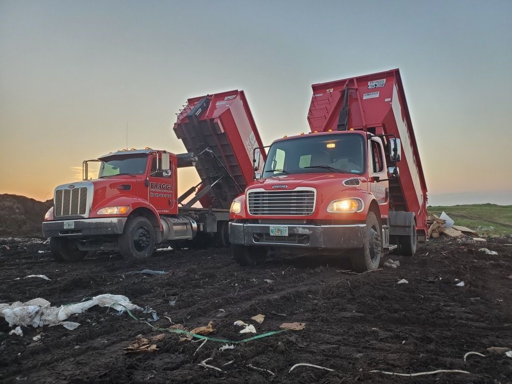 Two Dumpster Trucks Disposing Waste — Melbourne, FL — Braggs Roll-Off Dumpsters Inc.