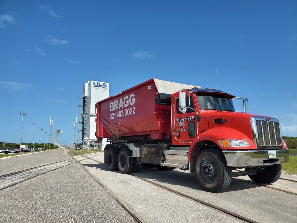 Bragg Dumper — Melbourne, FL — Braggs Roll-Off Dumpsters Inc.