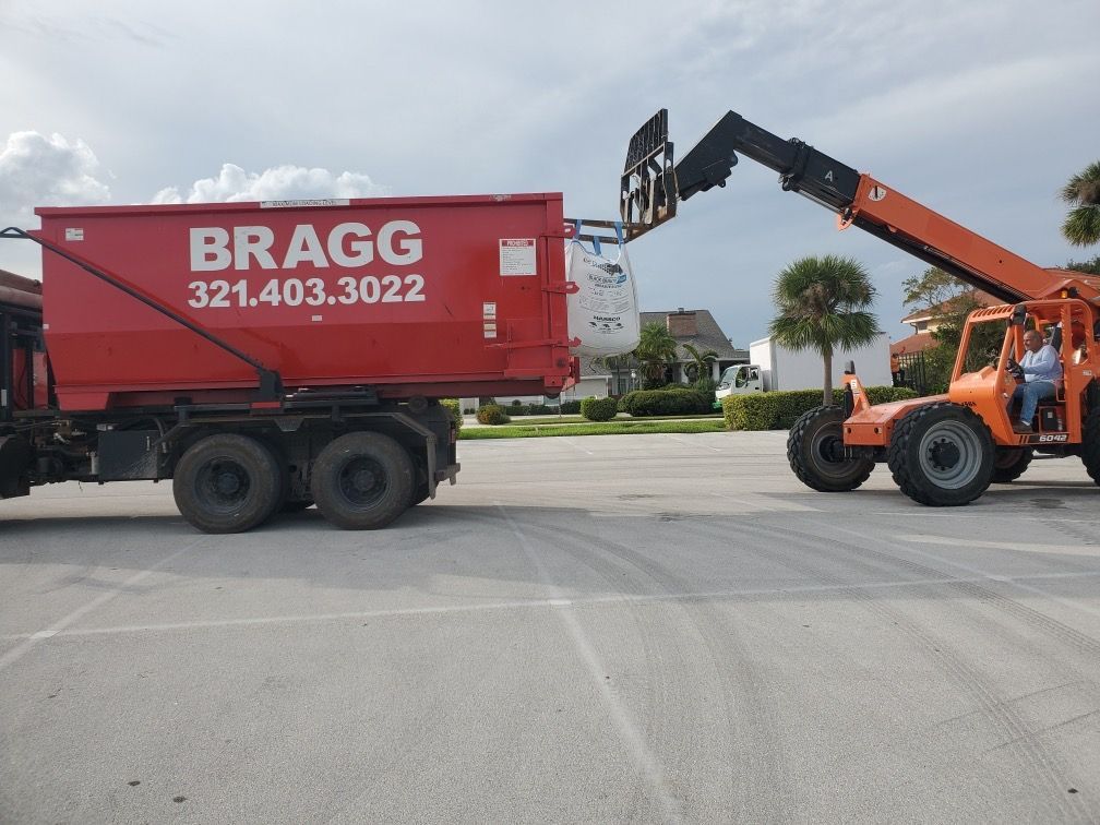 Waste Filling a Dumpster Truck — Melbourne, FL — Braggs Roll-Off Dumpsters Inc.