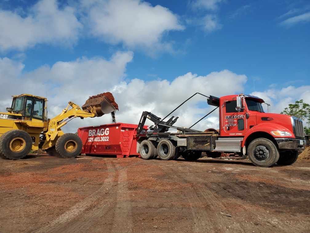 Dumpster Filling Up with Soil — Melbourne, FL — Braggs Roll-Off Dumpsters Inc.