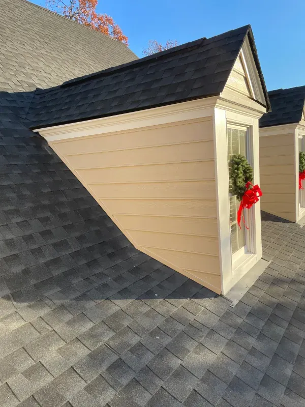 off white siding for window that jut out of a roof line
