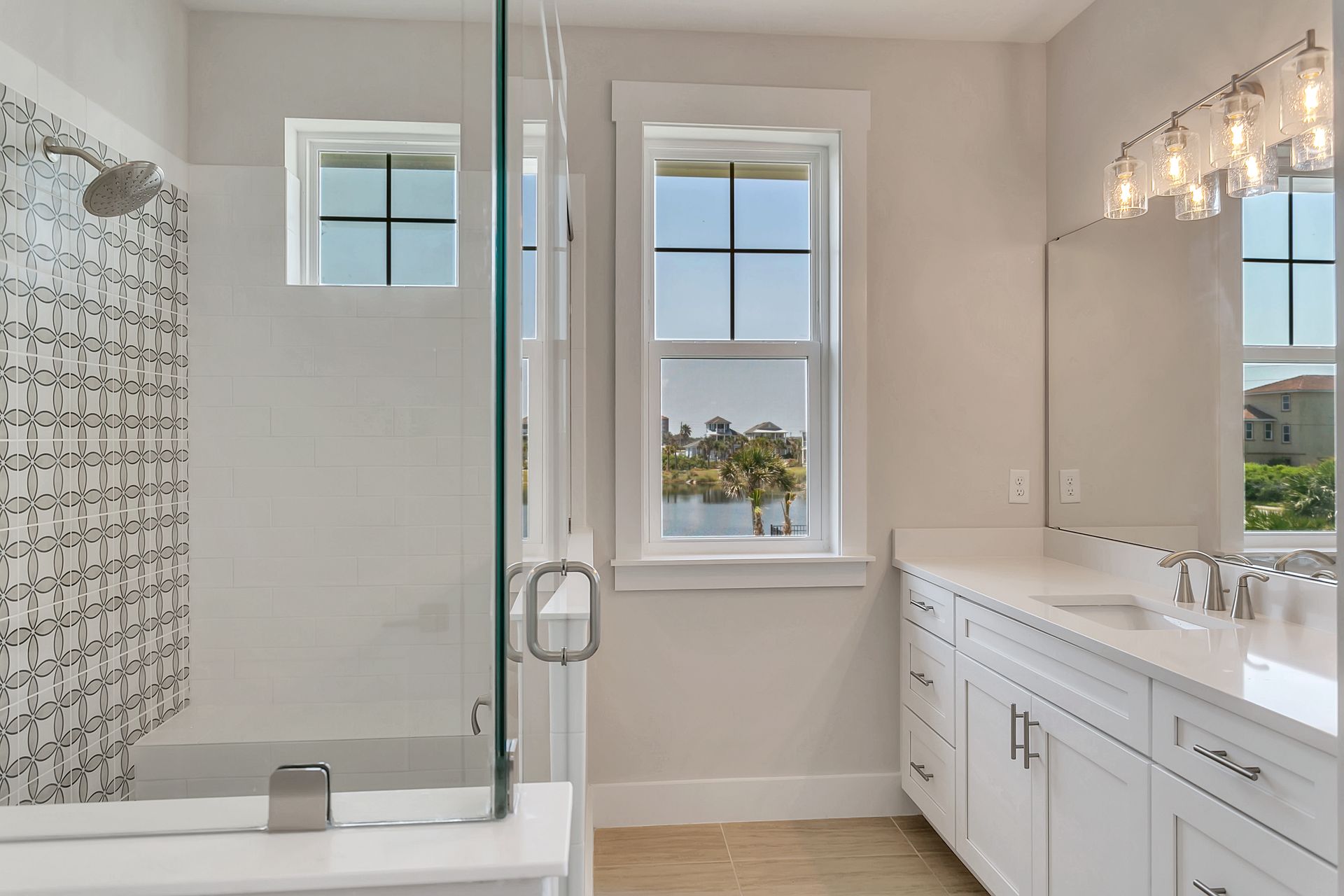 A bathroom with a walk in shower , sink , and mirror.