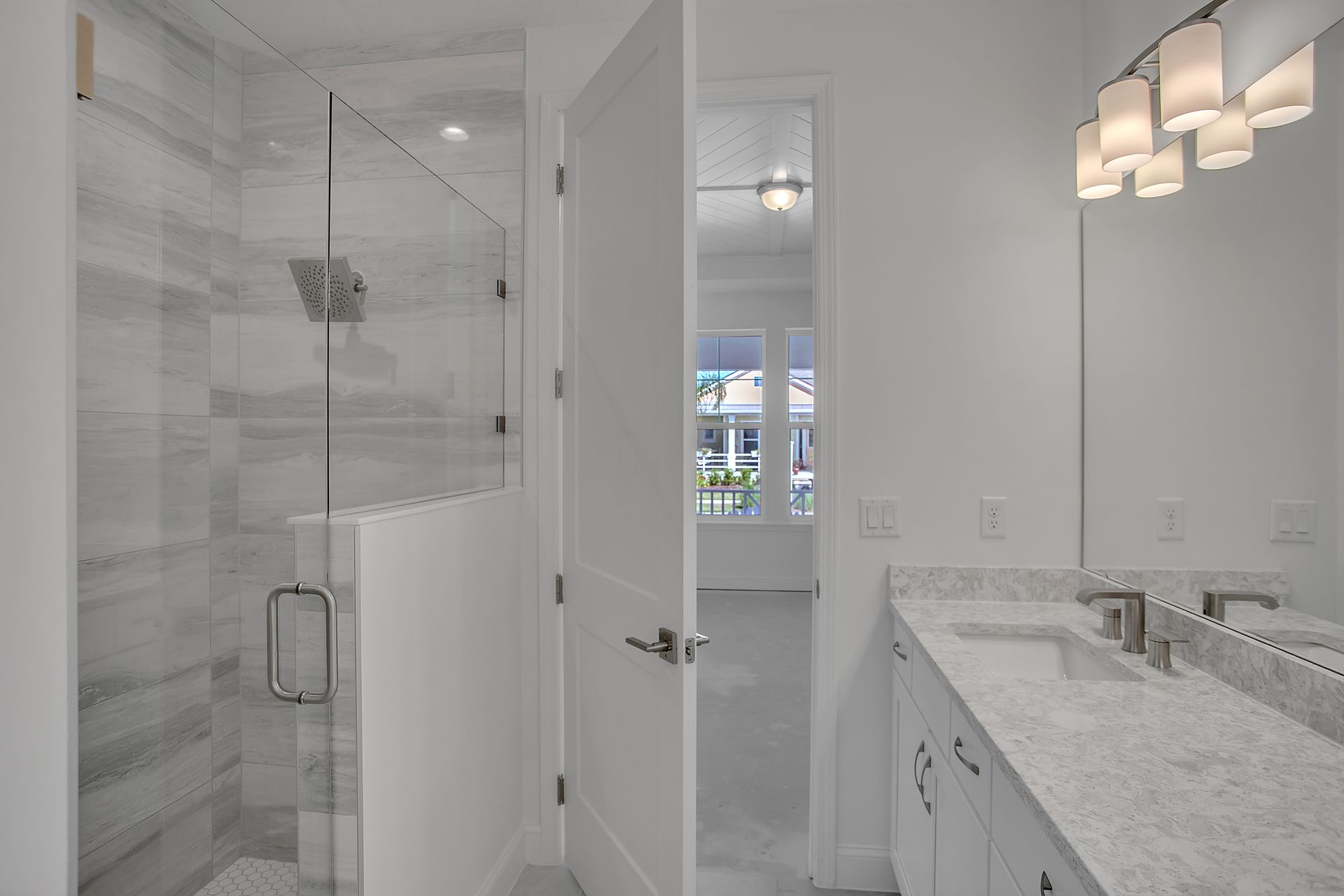 A bathroom with a walk in shower and two sinks