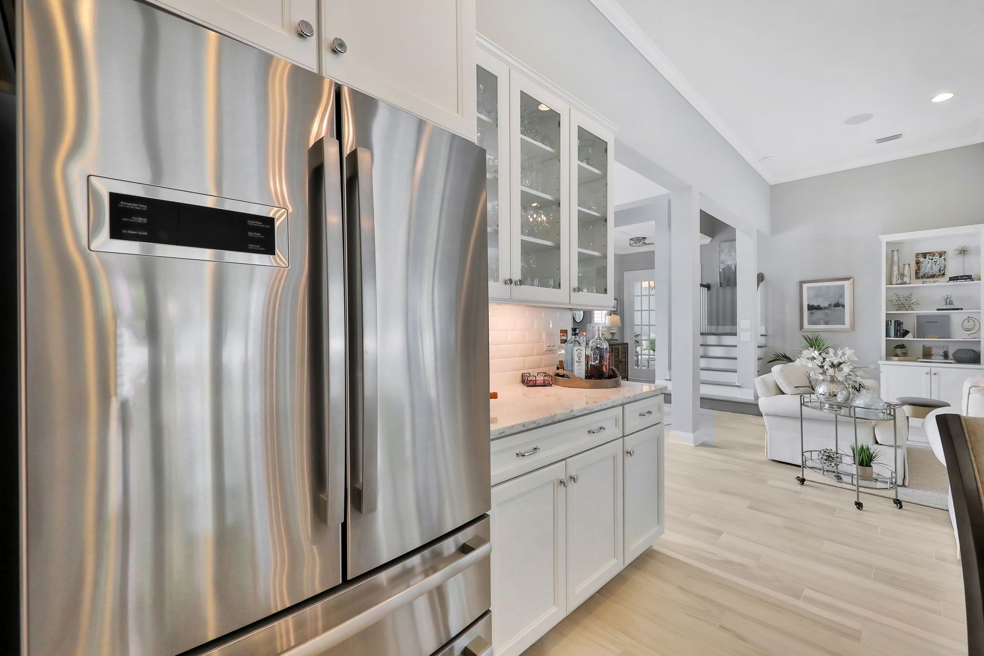 A kitchen with stainless steel appliances and white cabinets.