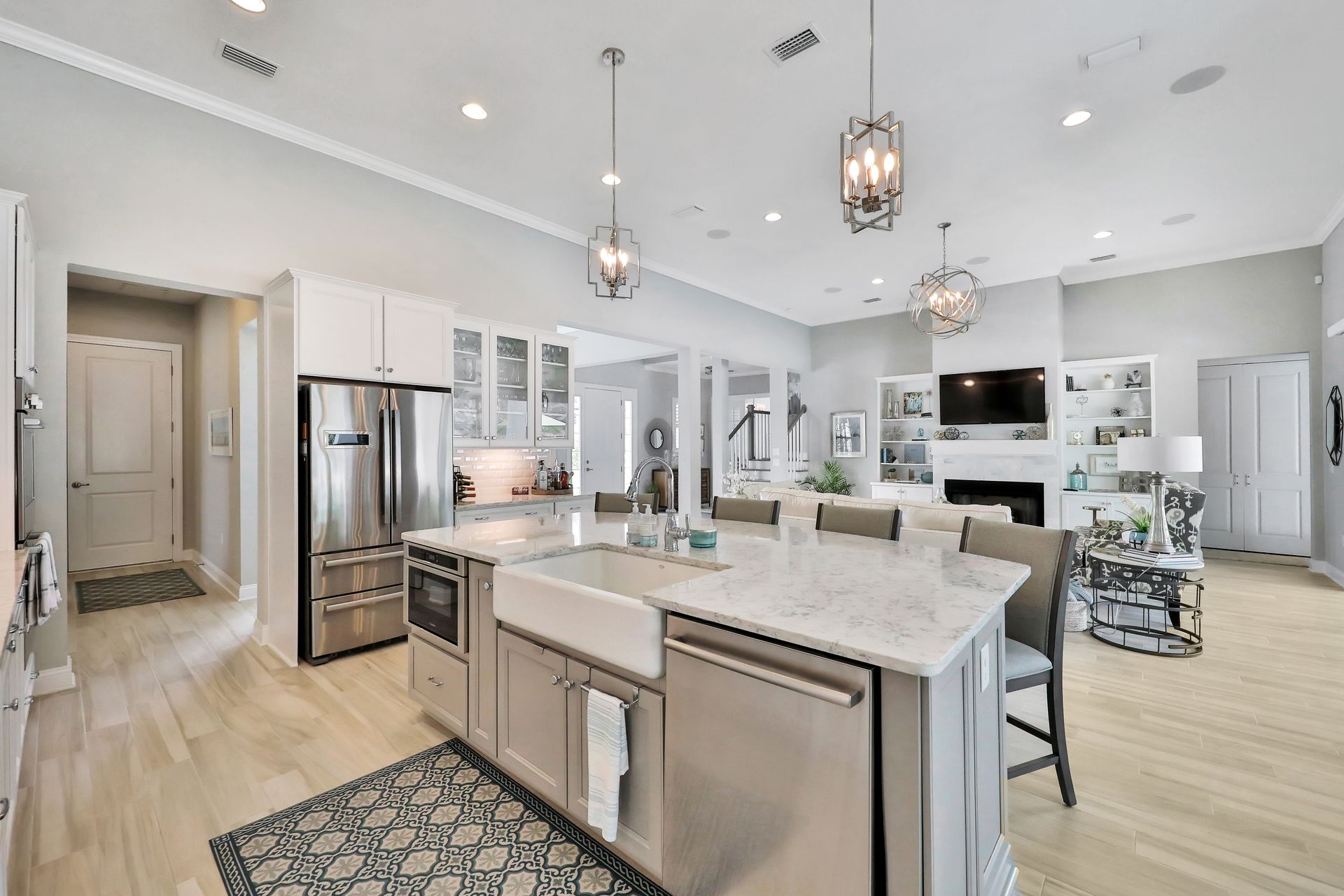 A kitchen with stainless steel appliances and a large island in the middle of the room.