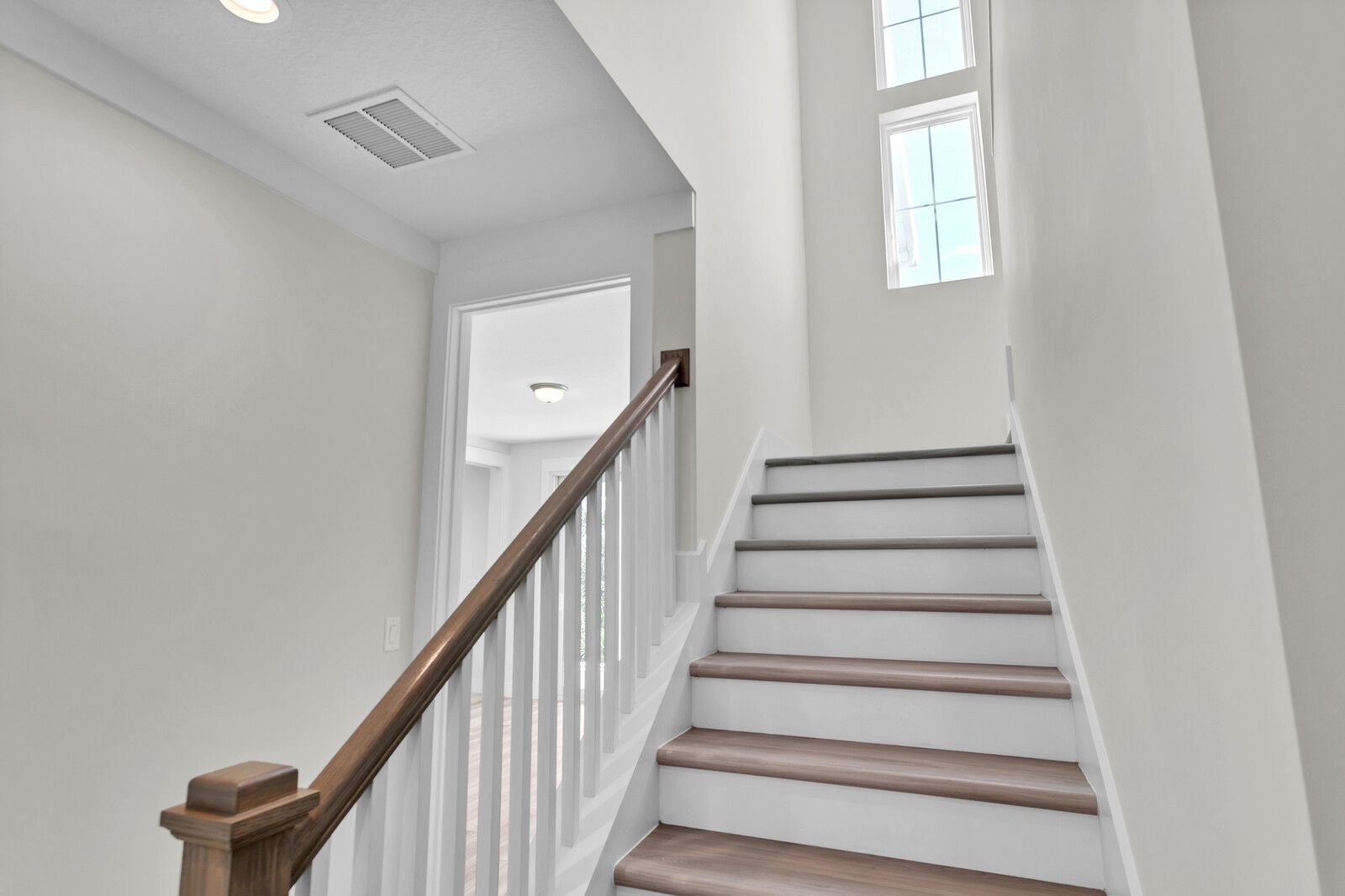 A set of stairs leading up to the second floor of a house.