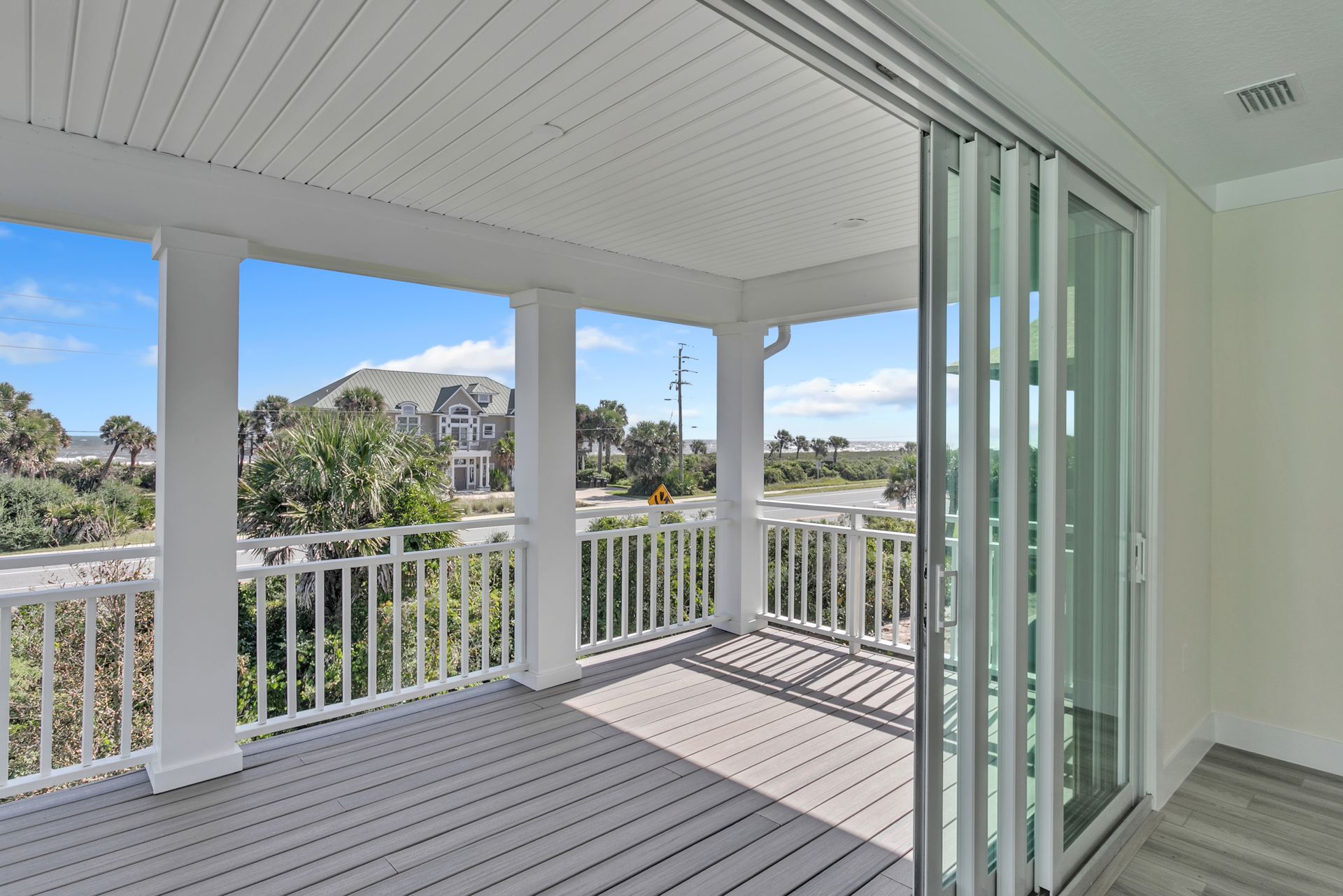 An empty deck with a sliding glass door