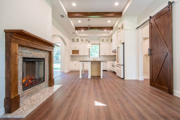 There is a fireplace in the middle of the living room.