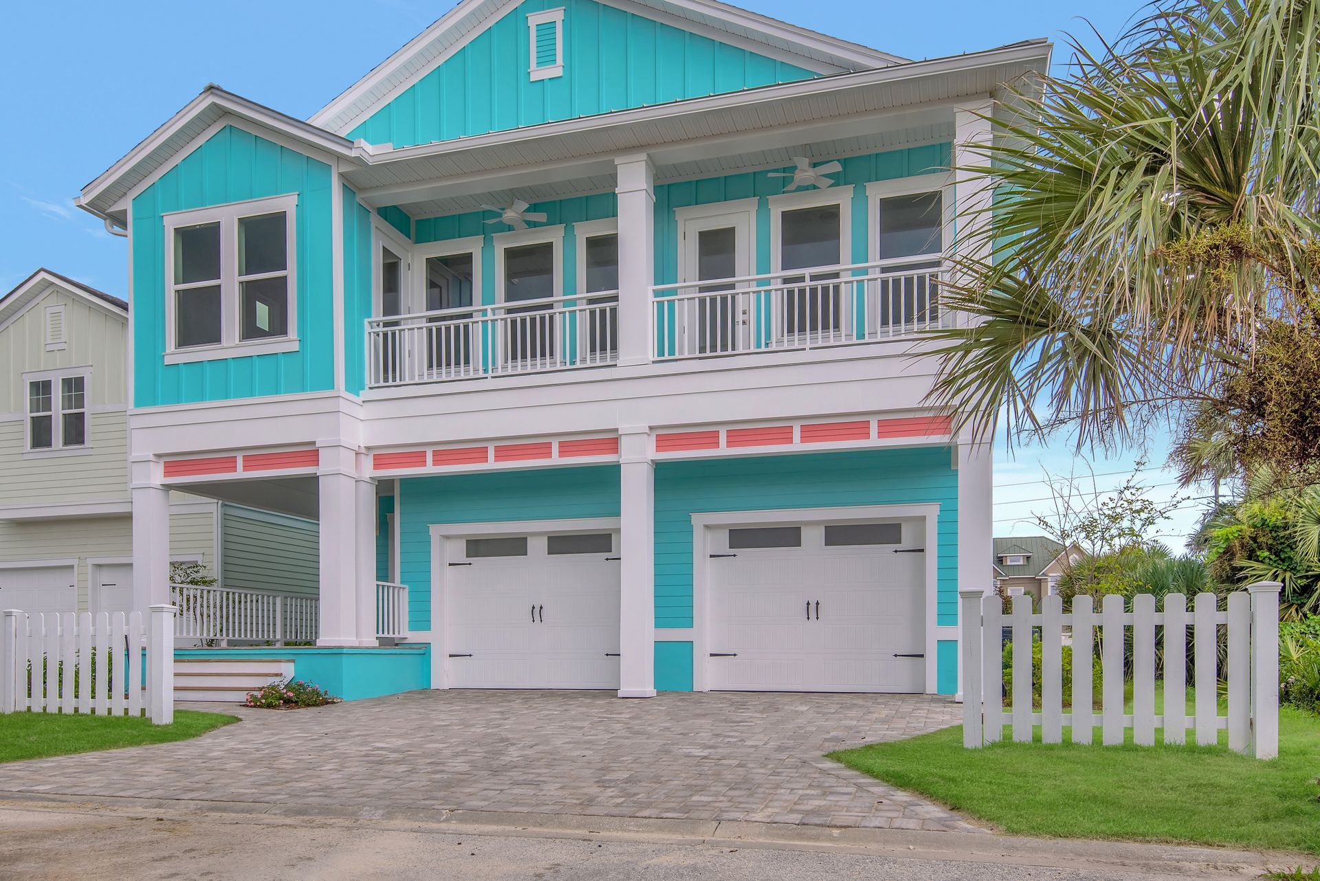 A blue and white house with a white picket fence