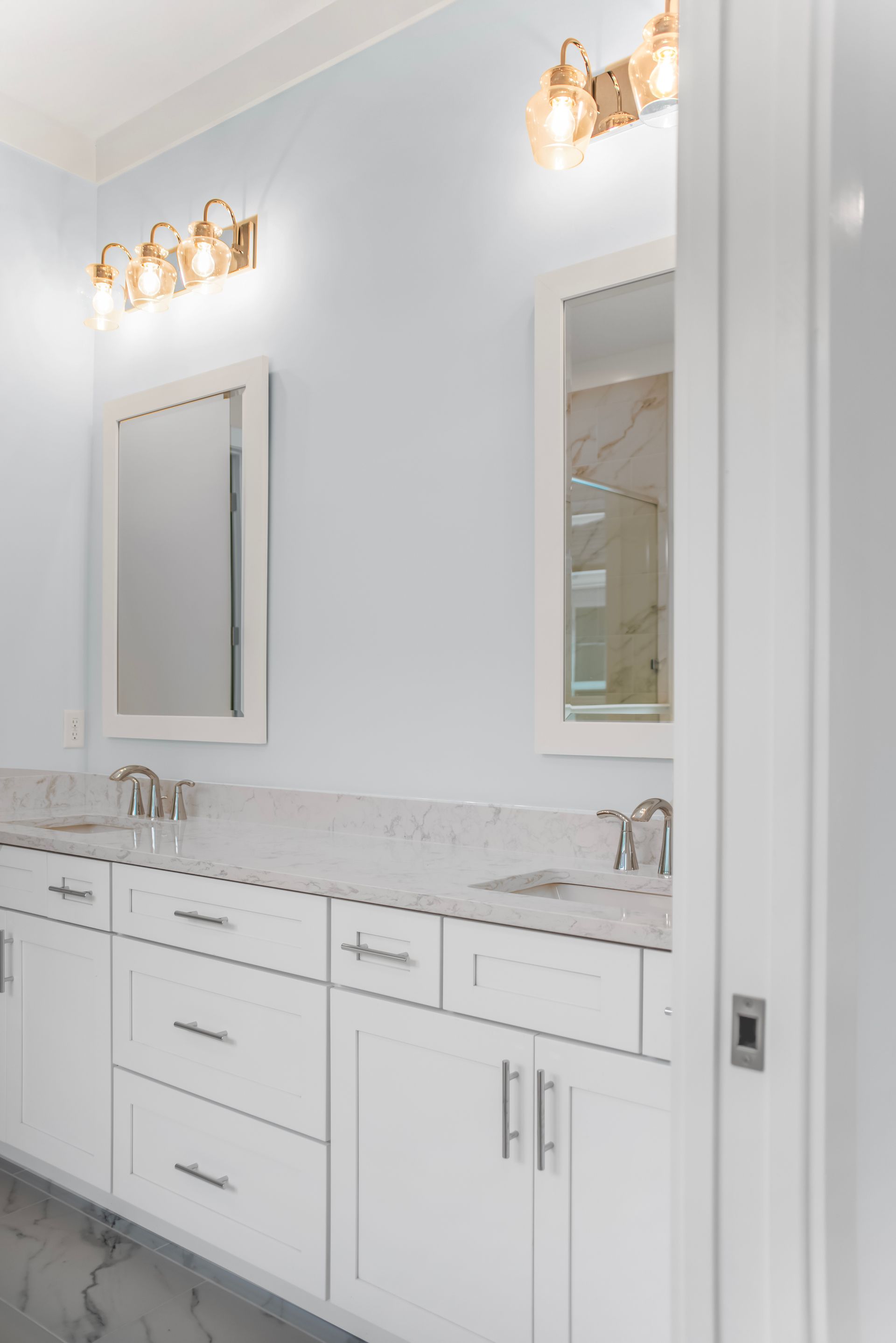 A bathroom with two sinks and a mirror.