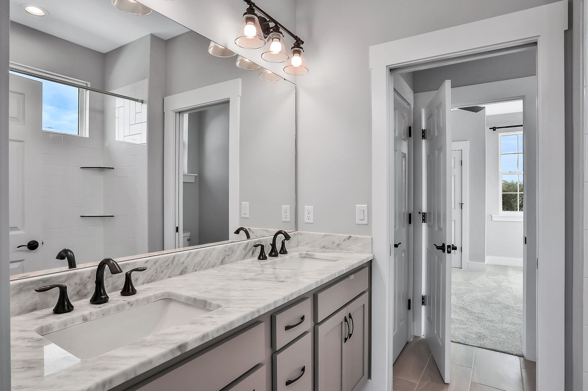 A bathroom with two sinks and a large mirror.