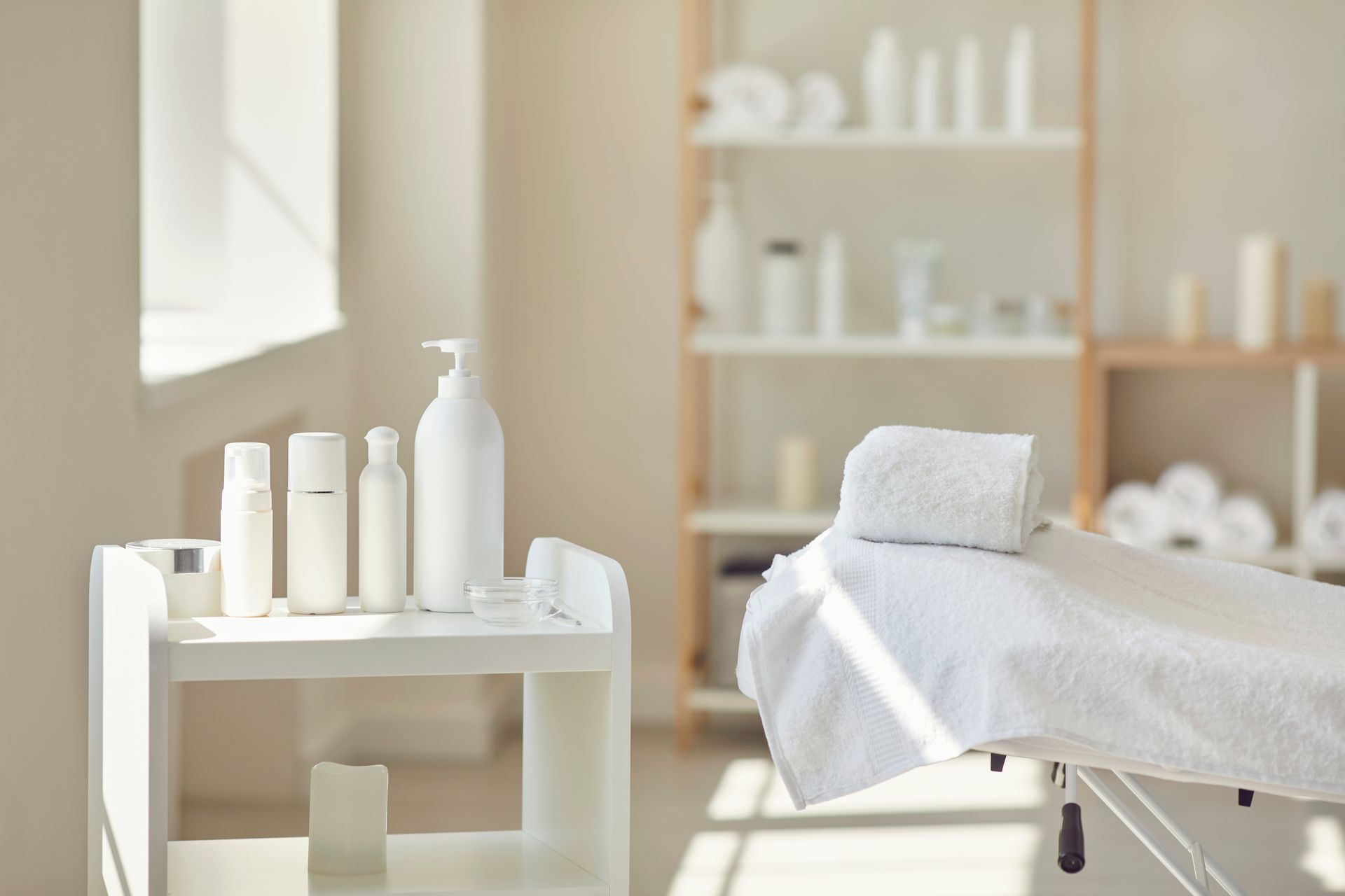 Spa treatment room with a massage table and skincare products.