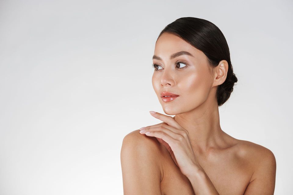 Woman with her hand on her shoulder at ERA Wellness Spa in Georgetown, KY