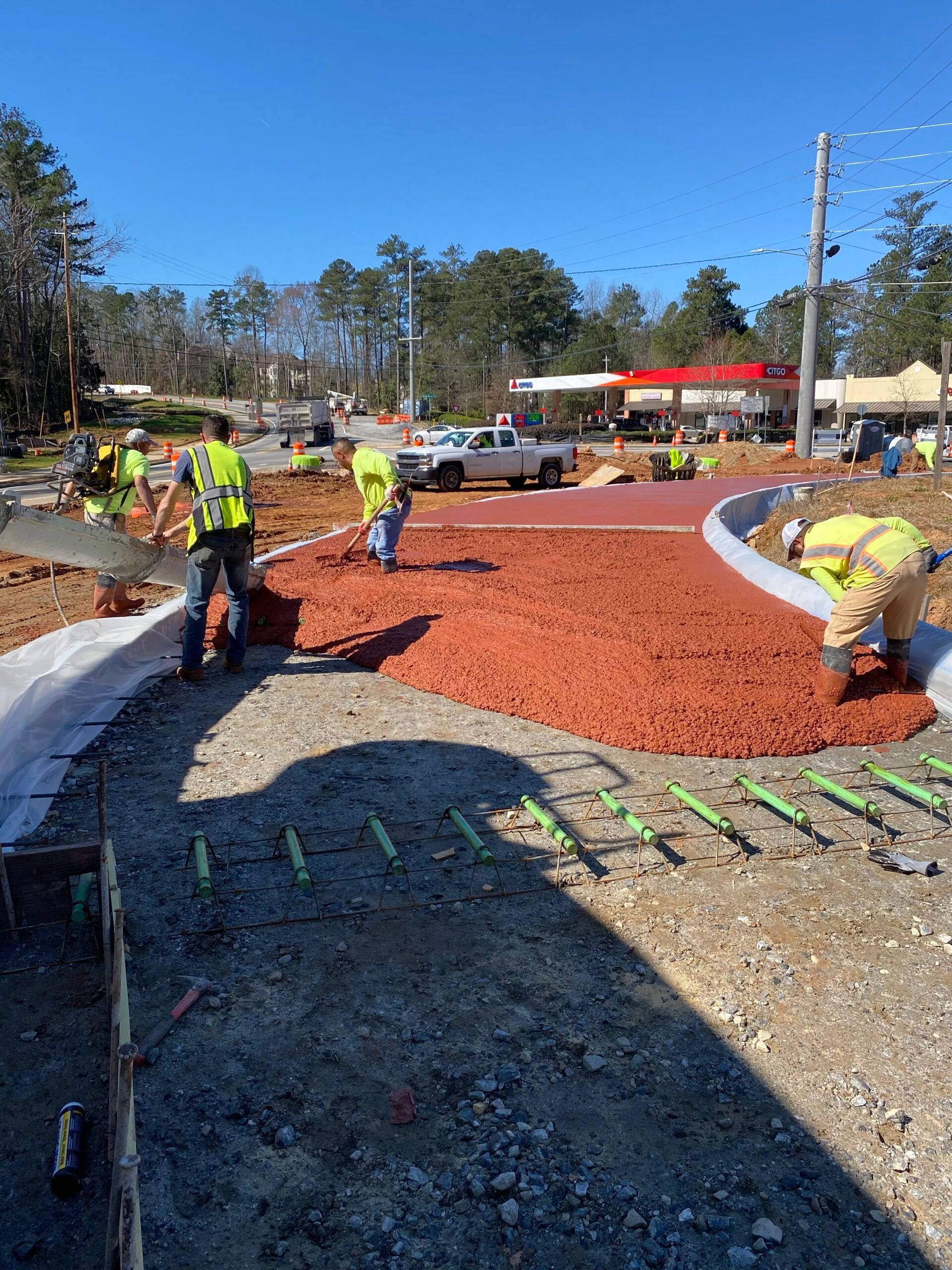 A group of construction workers are working on a road.