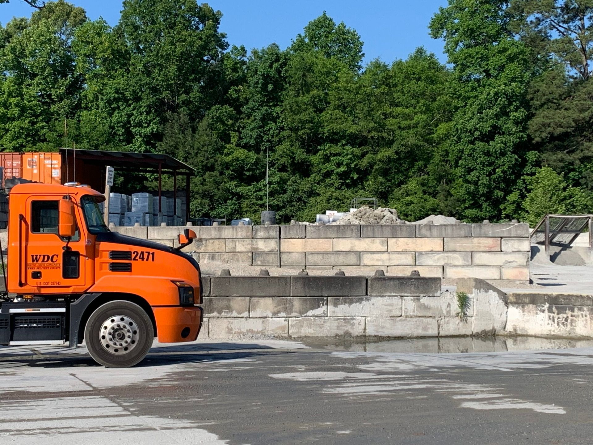 An orange truck with 24/7 written on the side
