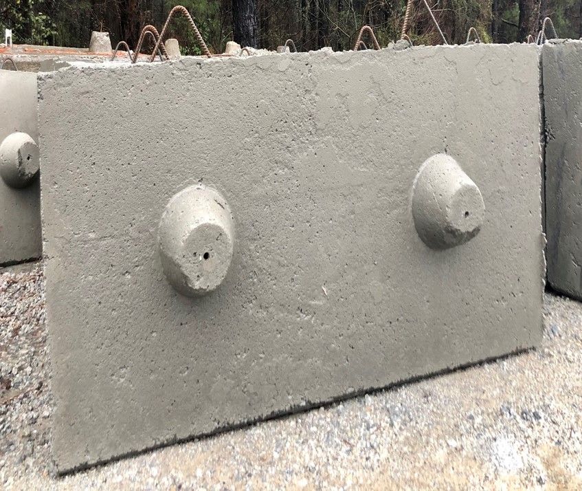 A concrete block with two holes in it is sitting on the ground.