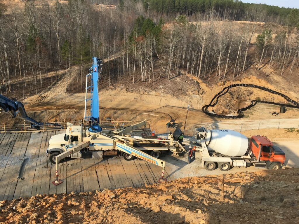 A concrete pump is being used to pump concrete into a concrete slab.