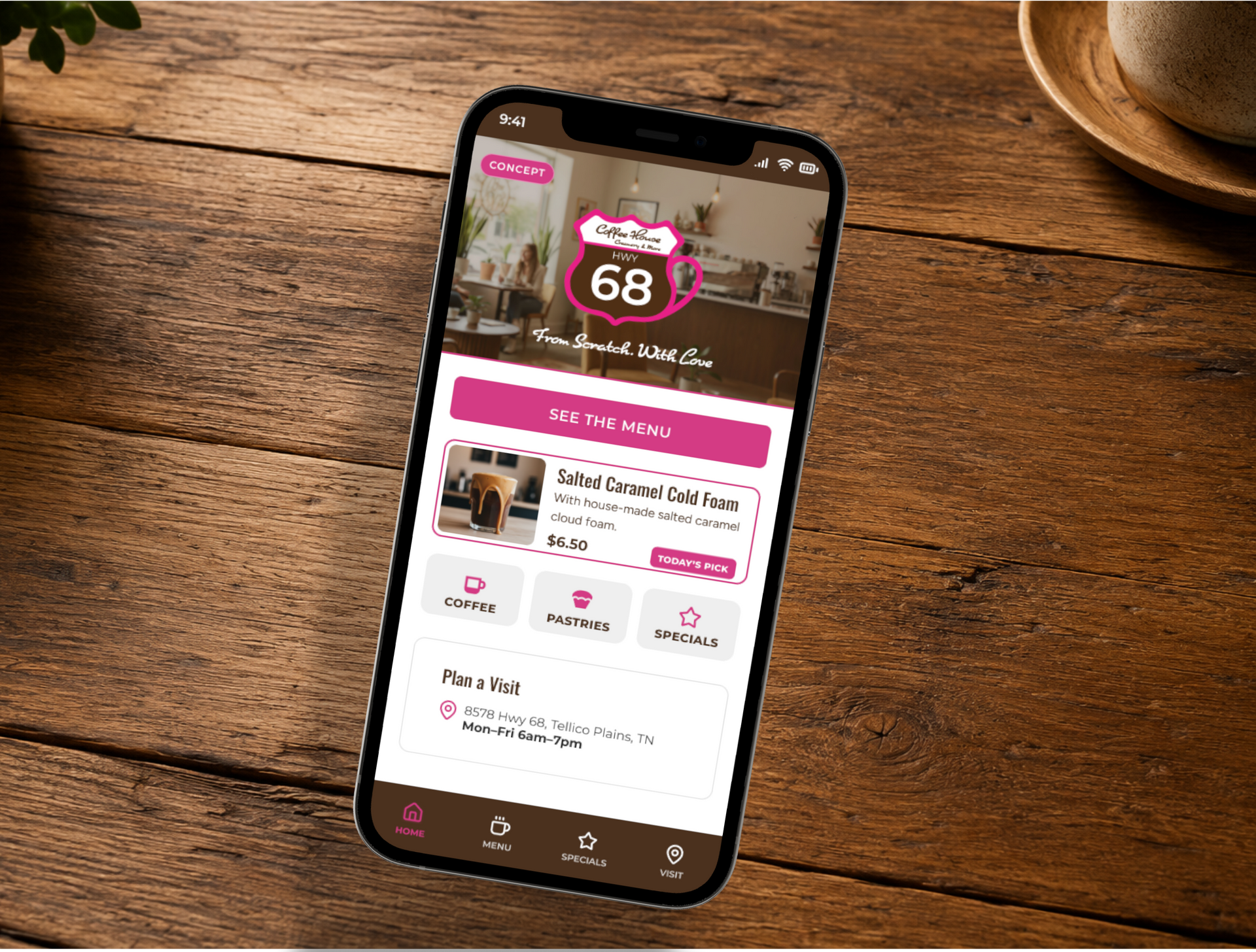 Smartphone on wooden table showing the HWY68 mobile app home screen.