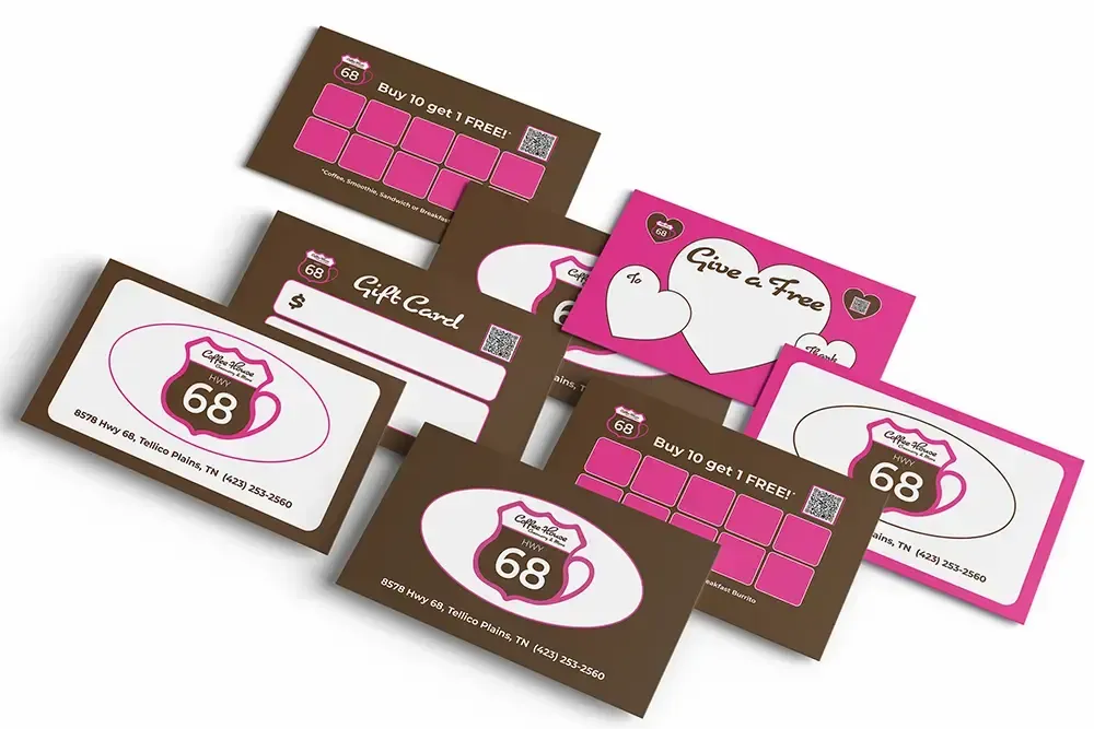 Assorted pink and brown business cards with logo and “68” design, fanned out on a white background