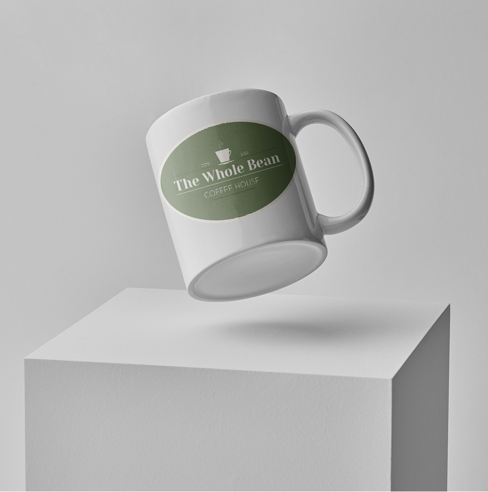 White mug with green “Tree Whole Bean” label floating above a white pedestal.