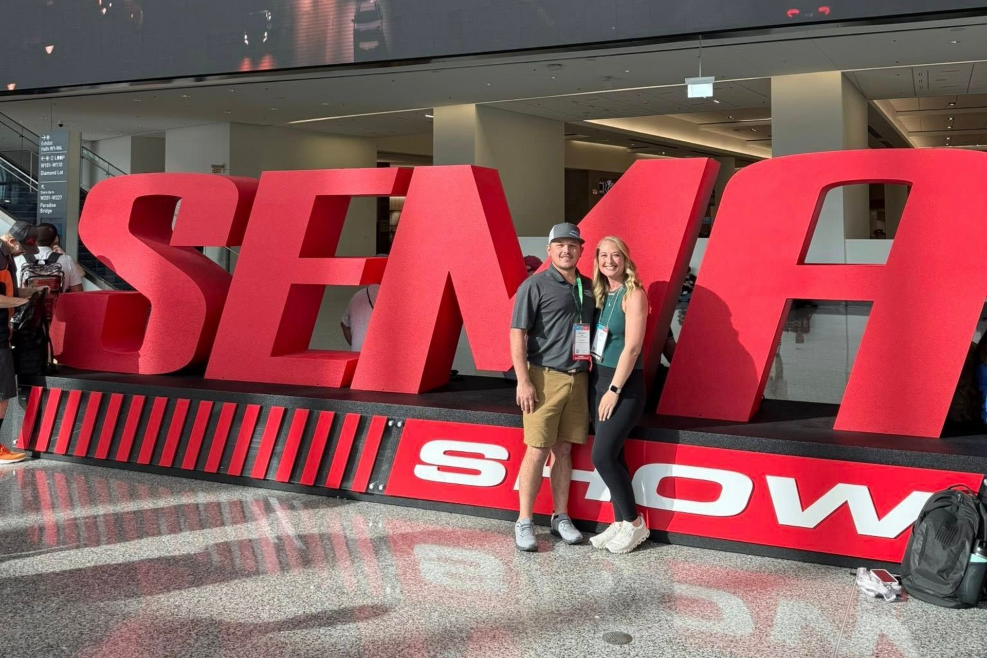 Couple poses in front of giant red 