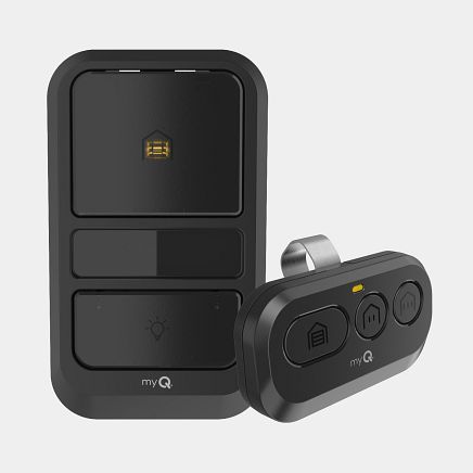 Black MyQ garage door opener and remote control, on light background.