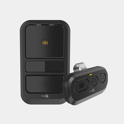 Black garage door opener and remote. The remote has three buttons and a clip.
