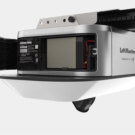 LiftMaster garage door opener with backup battery compartment open, showing battery.