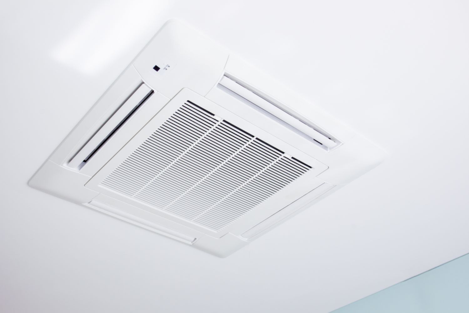 A White Air Conditioner is Mounted to the Ceiling — NDR Trade Solutions in Robina, QLD