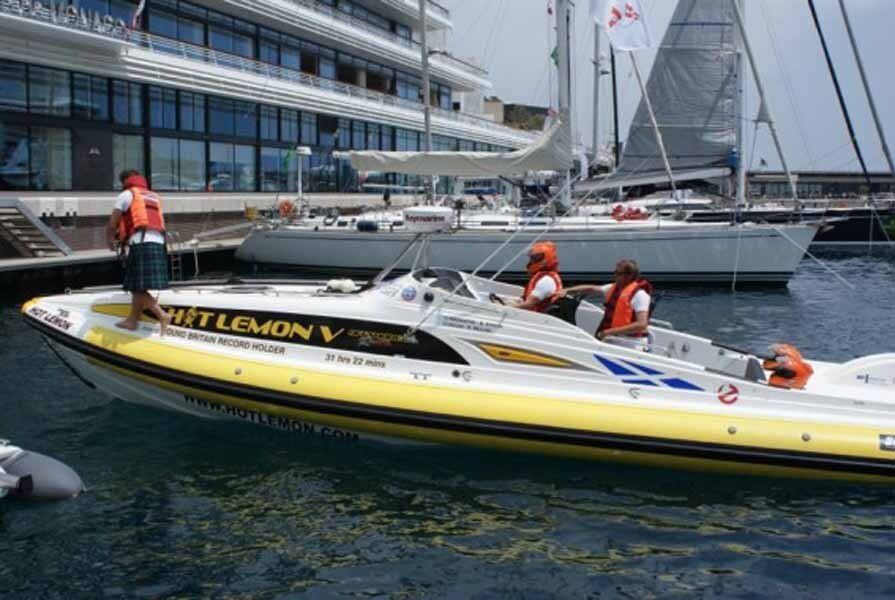 A yellow and white boat is floating on top of a body of water.